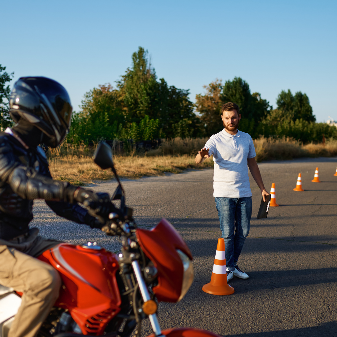 Instruktor prowadzi jazdę kursanta na motocyklu wśród pachołków — plac manewrowy w Koszalinie